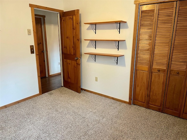 unfurnished bedroom featuring light carpet, baseboards, and a closet