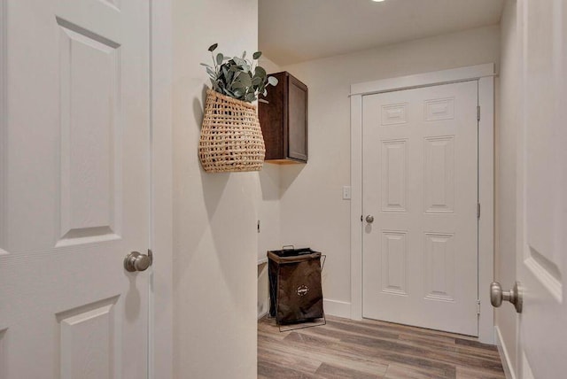 interior space with baseboards and wood finished floors