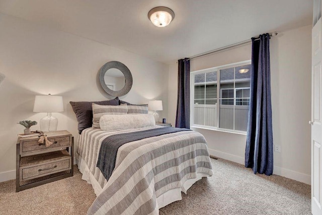 bedroom with baseboards and carpet floors