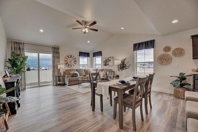 dining space with baseboards, ceiling fan, vaulted ceiling, recessed lighting, and light wood-style flooring