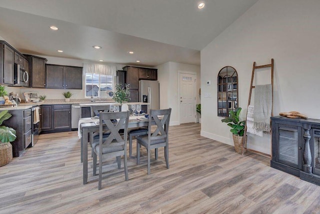 dining space featuring recessed lighting, baseboards, vaulted ceiling, and light wood finished floors