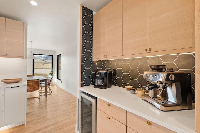 kitchen featuring light countertops, beverage cooler, and tasteful backsplash