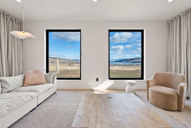 living room with a wealth of natural light, recessed lighting, and baseboards