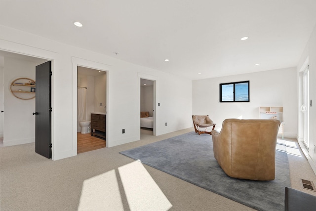 living area with recessed lighting, visible vents, and carpet floors