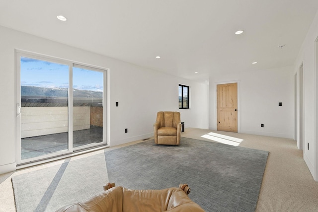 living area featuring recessed lighting, baseboards, and carpet flooring