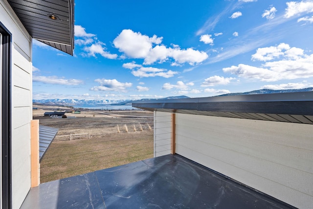 view of patio with a mountain view and a balcony