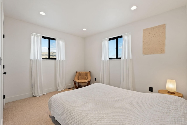 bedroom with recessed lighting, multiple windows, and light colored carpet