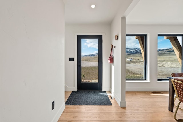 entryway featuring light wood-style flooring, recessed lighting, and baseboards