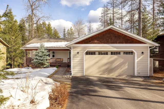 view of front of house featuring covered porch and a garage