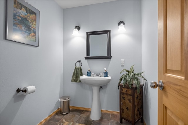 bathroom with baseboards and tile patterned flooring