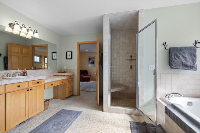 bathroom with vanity, a garden tub, and a stall shower