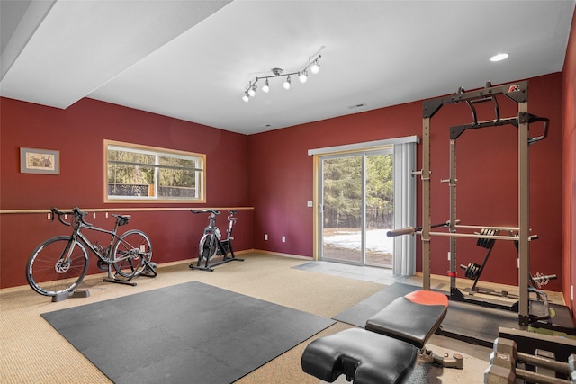 exercise room with baseboards, carpet floors, and visible vents