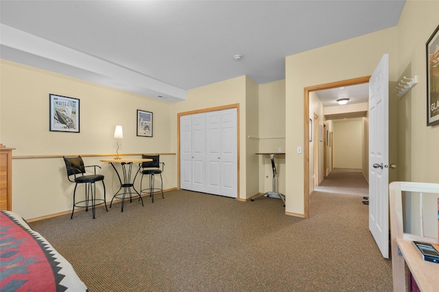 carpeted bedroom with baseboards and a closet