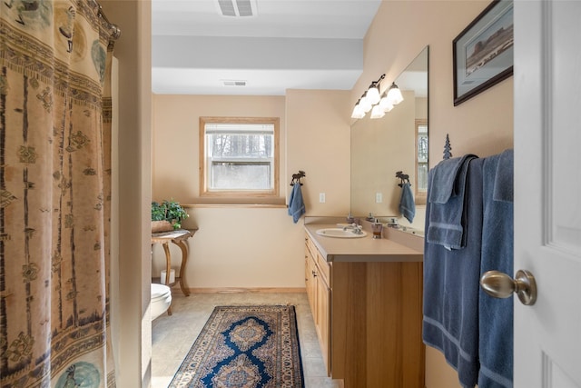 bathroom featuring visible vents, toilet, vanity, and tile patterned flooring