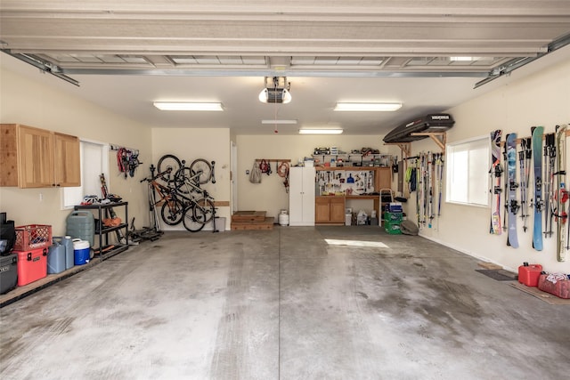 garage with a workshop area and a garage door opener