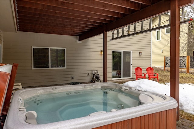 view of swimming pool with a hot tub