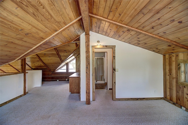 additional living space with wood walls, wooden ceiling, baseboards, and lofted ceiling