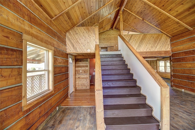 stairway featuring wooden ceiling, wood walls, lofted ceiling with beams, and hardwood / wood-style floors