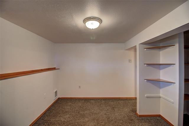 unfurnished room featuring baseboards, visible vents, carpet floors, and a textured ceiling