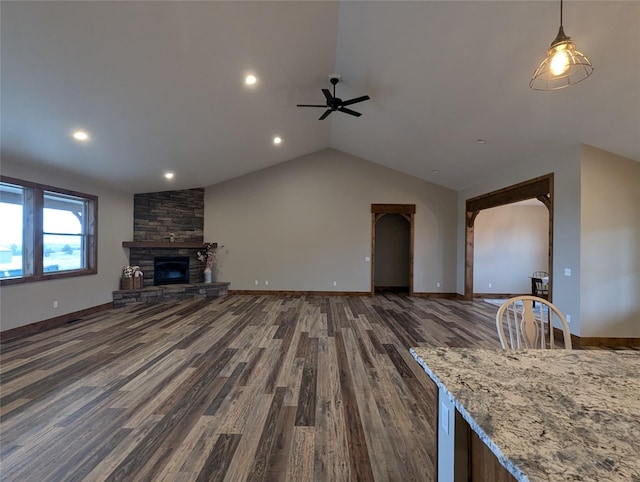 315 Franklin Mine Rd, Helena, MT 59602 - unfurnished living room with a ceiling fan, dark wood-type flooring, lofted ceiling, a stone fireplace, and recessed lighting