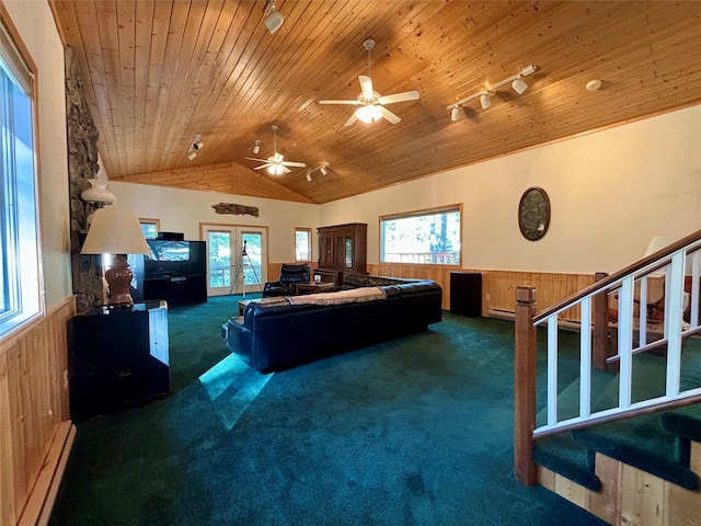 living area featuring wainscoting, a baseboard heating unit, and carpet