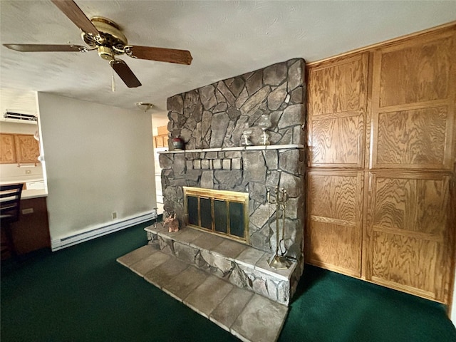 carpeted living area featuring ceiling fan, a fireplace, and a baseboard radiator