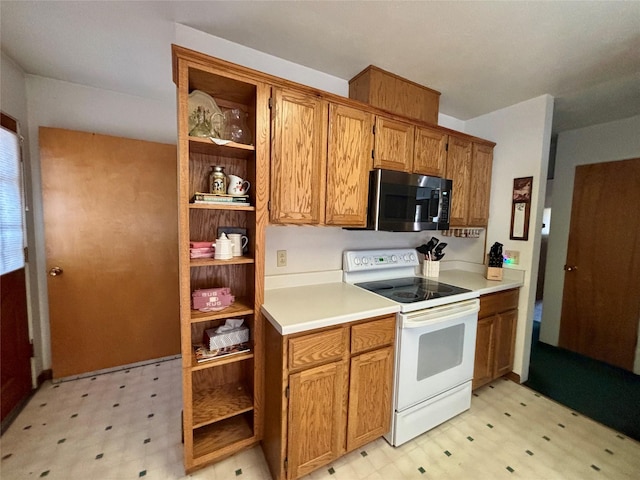 kitchen with white range with electric stovetop, stainless steel microwave, light floors, and open shelves