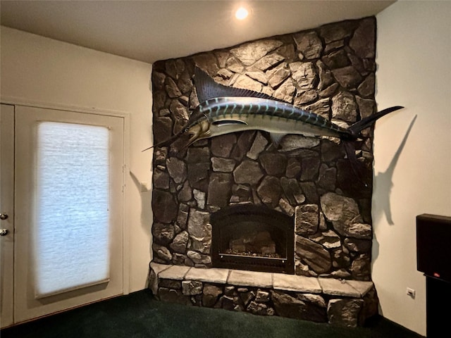 interior details with a fireplace and carpet