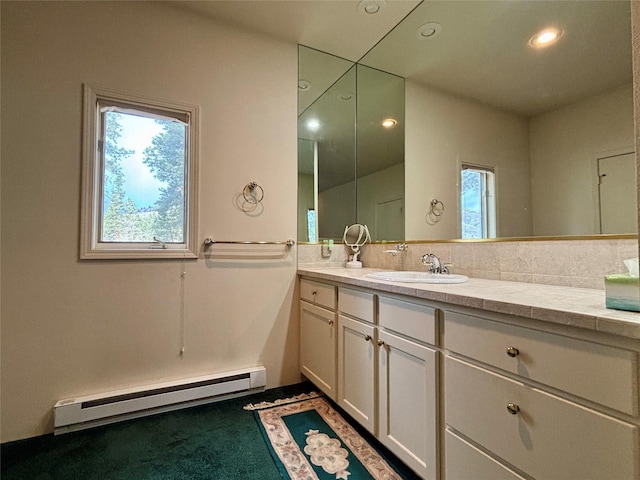 bathroom with vanity, recessed lighting, a wealth of natural light, and a baseboard radiator