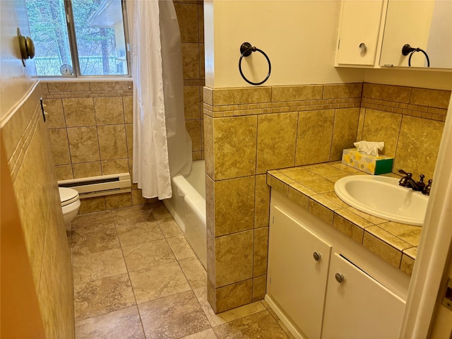 bathroom with vanity, shower / tub combo, tile walls, toilet, and baseboard heating