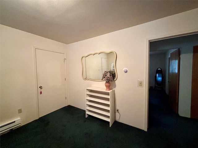 corridor featuring dark colored carpet and a baseboard radiator