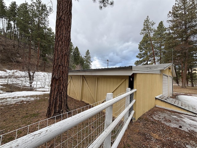 view of side of home with fence