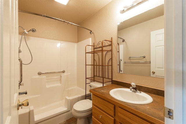 full bathroom featuring tub / shower combination, toilet, vanity, and a textured wall