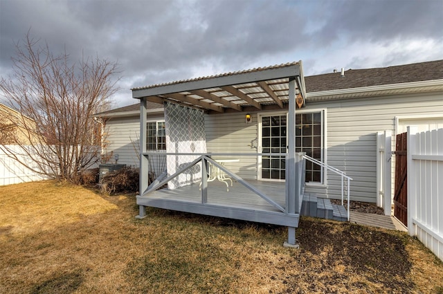 back of house with fence, a lawn, and a pergola