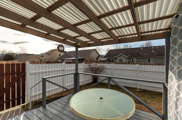 deck featuring a fenced backyard and a pergola