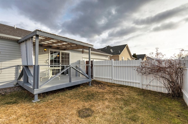 view of yard with a pergola, a deck, and fence