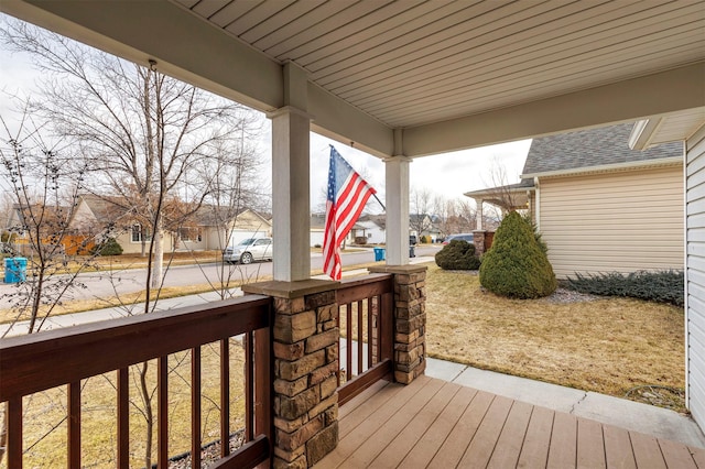 wooden deck with covered porch and a residential view