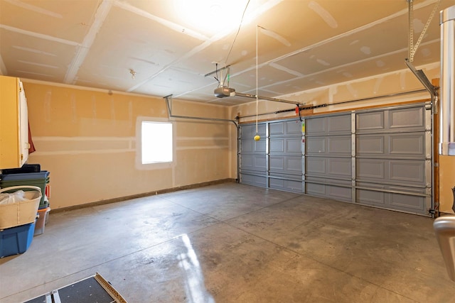 garage with a garage door opener and baseboards