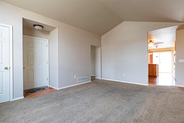 unfurnished room featuring vaulted ceiling, visible vents, carpet floors, and ceiling fan