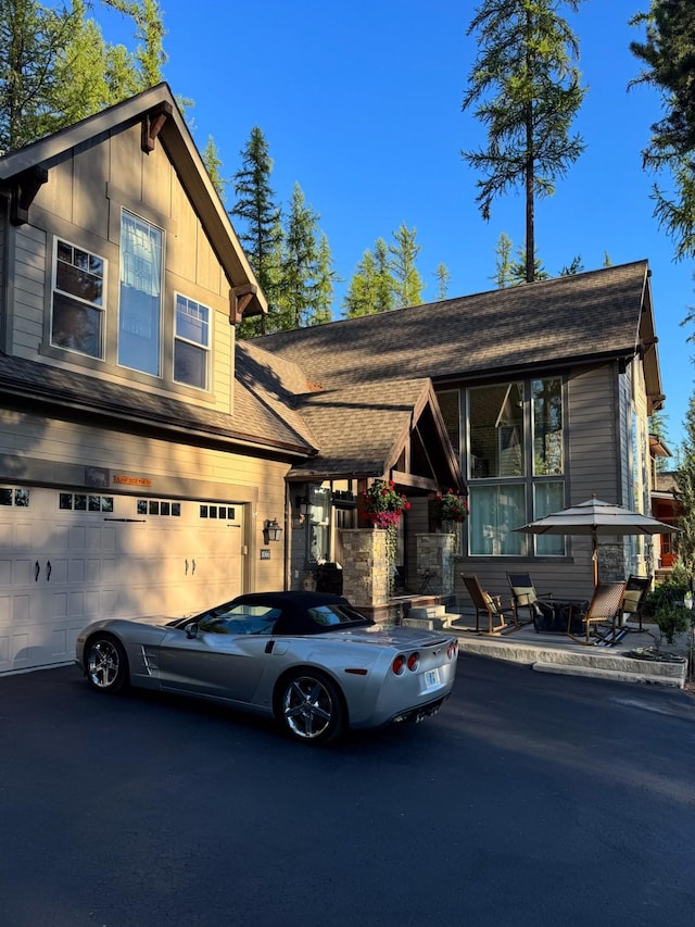 view of front of home with driveway and a garage