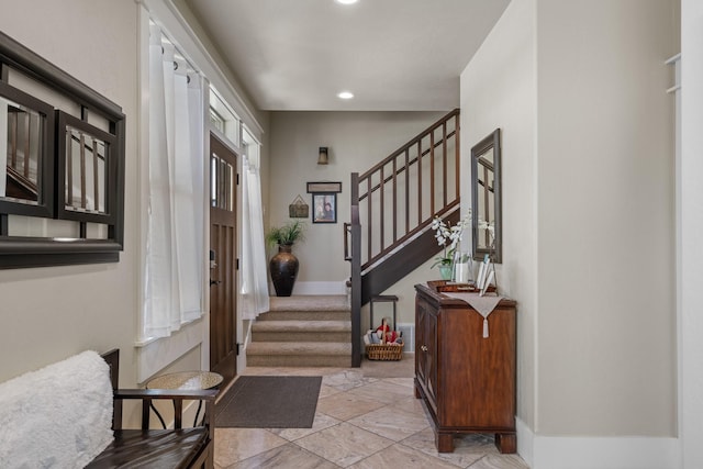 foyer with recessed lighting, baseboards, and stairs