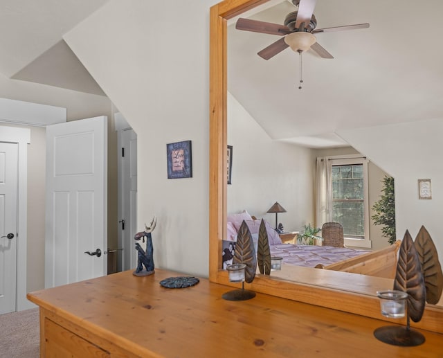 interior space with lofted ceiling, a ceiling fan, and carpet floors