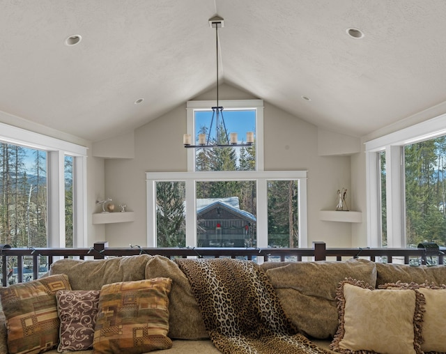 living room featuring a healthy amount of sunlight and high vaulted ceiling