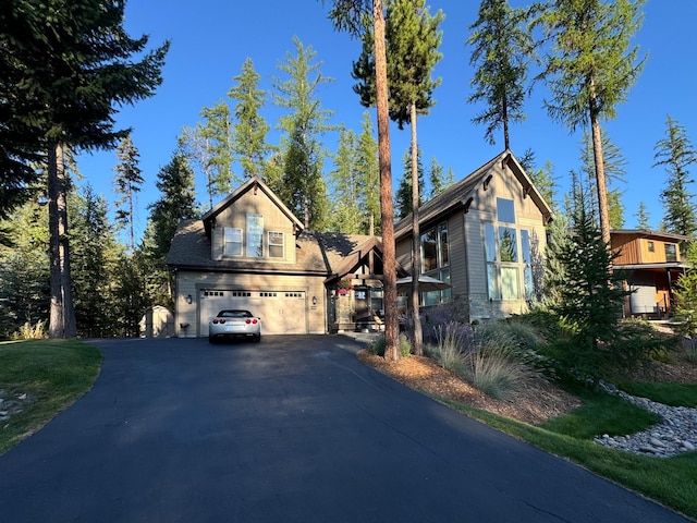 view of front facade with aphalt driveway and a garage