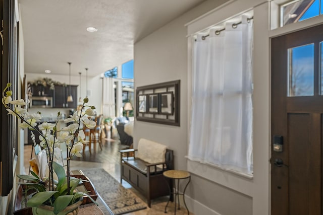 foyer featuring baseboards and wood finished floors