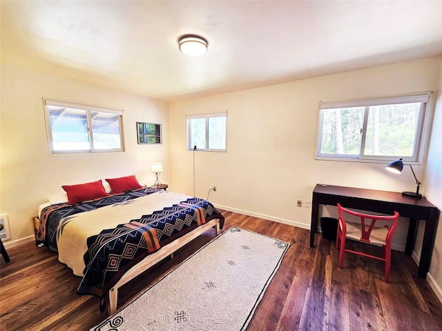 bedroom featuring wood finished floors and baseboards