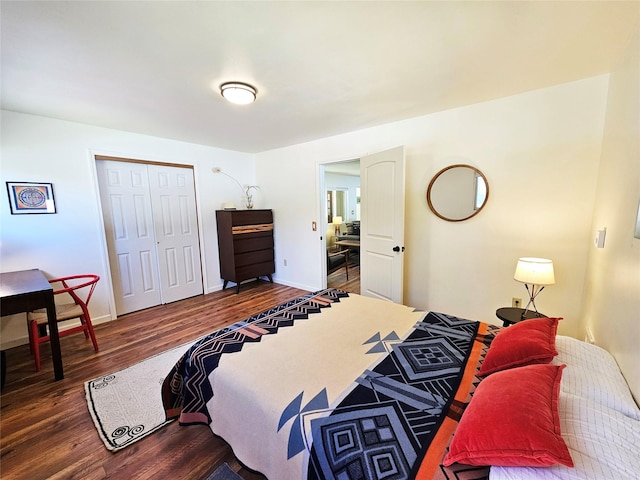 bedroom with a closet, baseboards, and dark wood-style floors