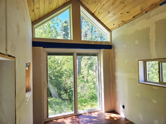 doorway with wood finished floors, wood ceiling, and high vaulted ceiling