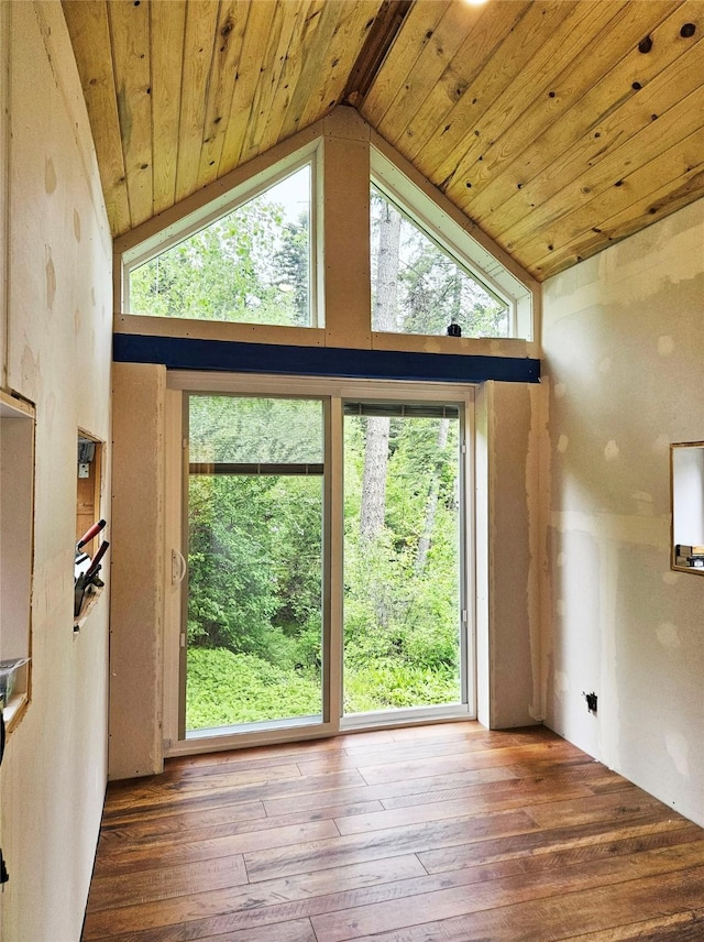 interior space with plenty of natural light, high vaulted ceiling, wood ceiling, and hardwood / wood-style flooring