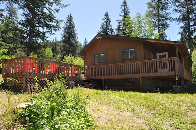 rear view of house featuring a wooden deck